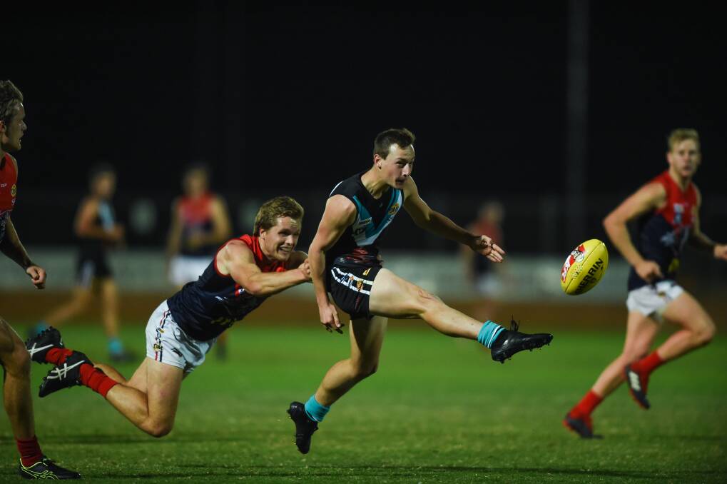 ENERGETIC ELIJAH: Lavington's Elijah Amery, who was a late replacement
for Adam Flagg after he suffered concussion a fortnight ago, gives
Jordan Rouse the slip. Picture: MARK JESSER