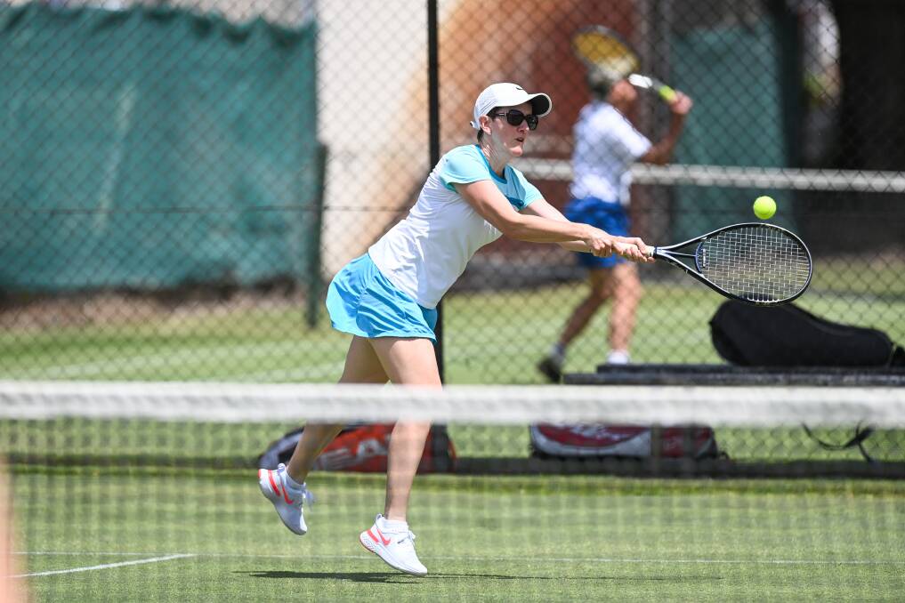 THAT'S A STRETCH: Forrest Hill's Helen Curtis reaches for a backhand during ladies division one against the Diamonds. Picture: MARK JESSER