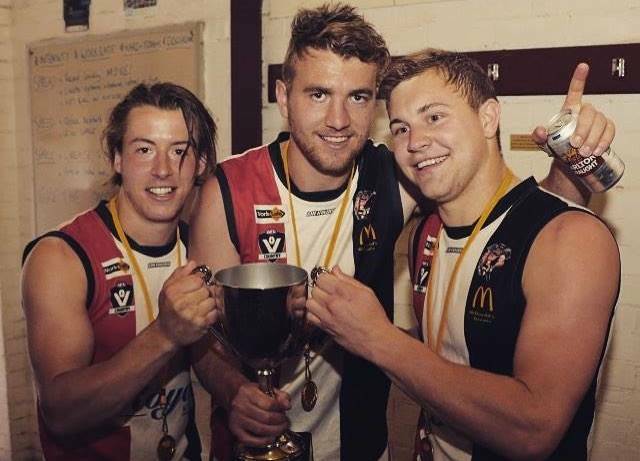 GREAT MATES: Nick Warnock (centre) has joined Sam Martyn (left) at Myrtleford, while another friend in Jake Pallpratt helps celebrate Benalla's 2015 premiership in the Goulburn Valley.