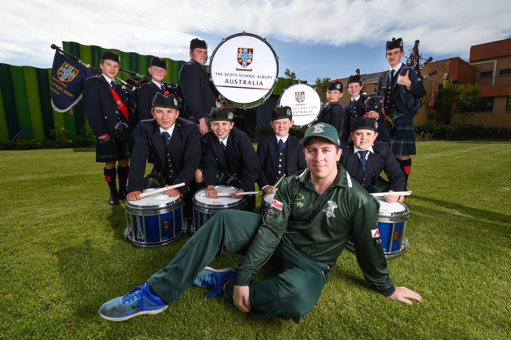 HOME FEELING: St Patrick's cricketer Neil Smith felt right at home when he caught up with The Scots School Albury Pipe Band. Picture: MARK JESSER