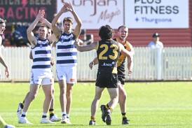 Albury's Jacob Conlan celebrates a goal with Rhys King (23), while Yarrawonga duo Logan Morey (left) and Dan Howe claim it was touched in the thriller on Saturday. Picture by Mark Jesser