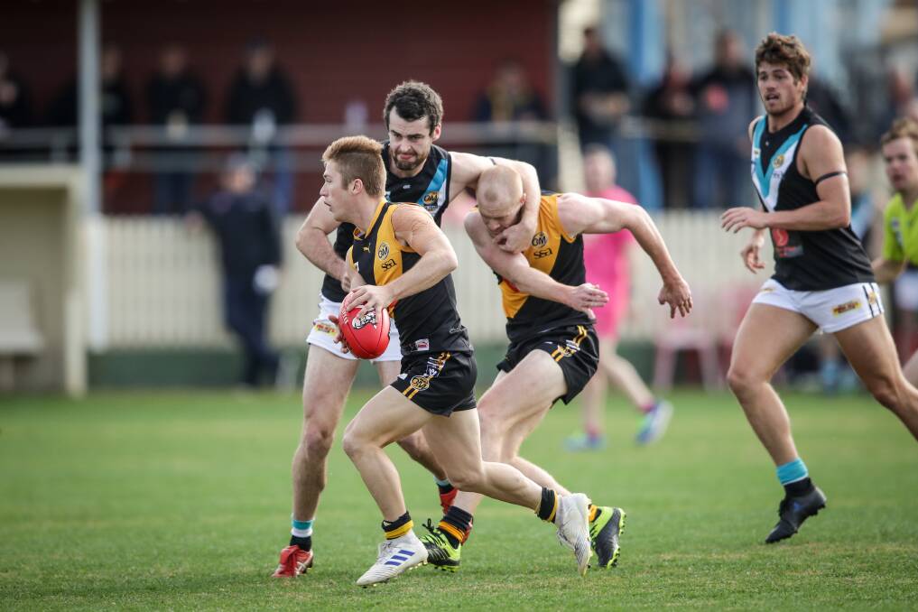 COME HERE: Lavington's Adam Flagg collars Kieran Ellis and then sets after Jake Gaynor in the pulsating top of the table clash. Lavington is now a game clear.