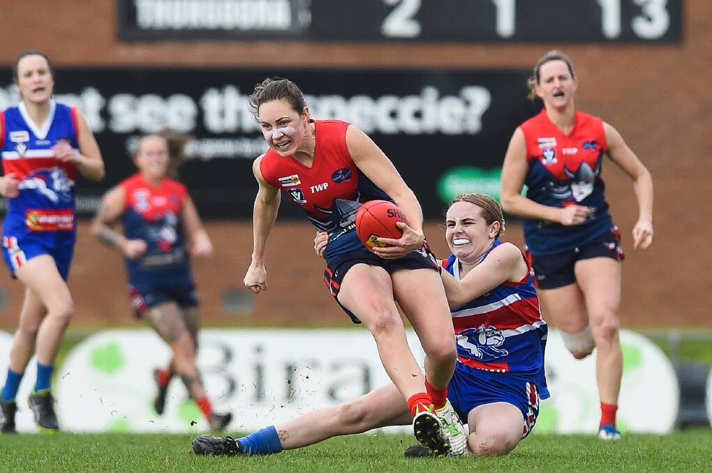 Wodonga Raiders' Rheanne Lugg tries to break the tackle of Thurgoona's Chelsea Hargreaves in last year's AFLNEB Female Football League Open grand final.