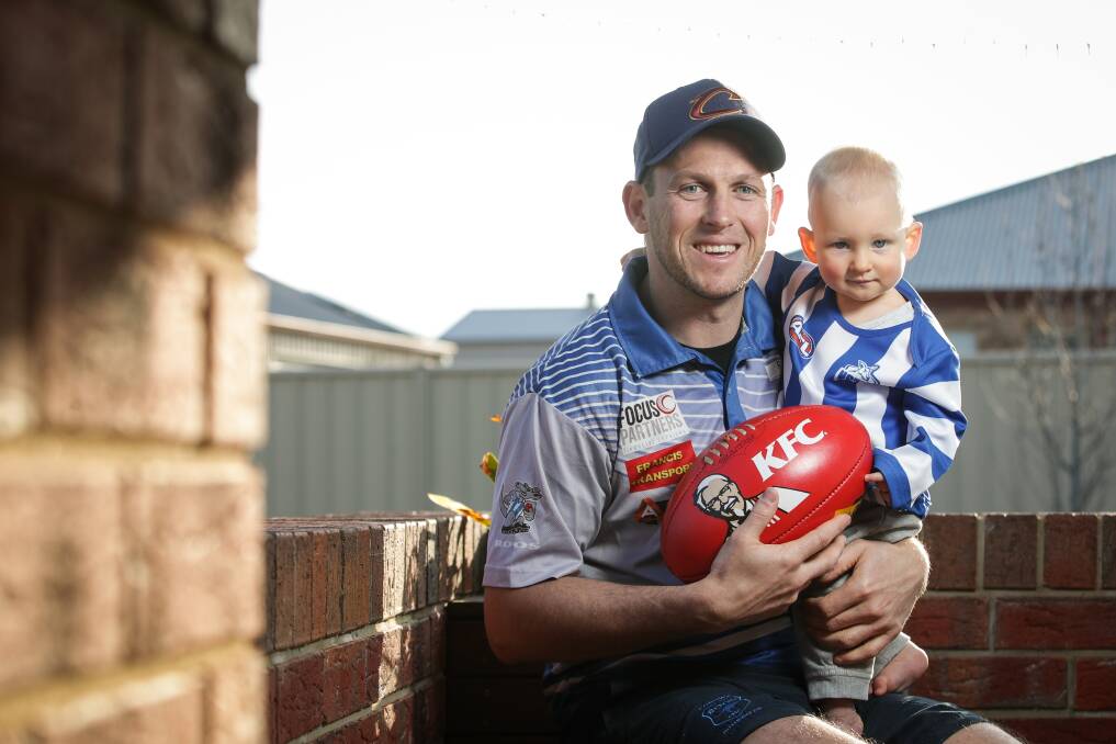 LOOK DOWN THE BARREL: Jamie Seymour's son, Jay, nine months, seems to have this photography caper down pat. His dad will be just as focused in his 200th game. Picture: JAMES WILTSHIRE