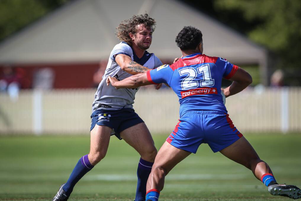 STRONG PALM: Bronson Meehan is on the receiving end of a fend from his Newcastle Knights opponent. The playmaker has put on 4kgs. Picture: JAMES WILTSHIRE