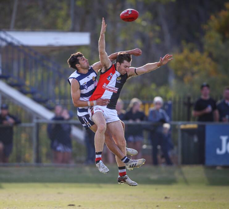 STRONG CONTEST: Yarrawonga's Leigh Masters (centre) spoils Myrtleford's Riley O'Shea during a third quarter marking contest.