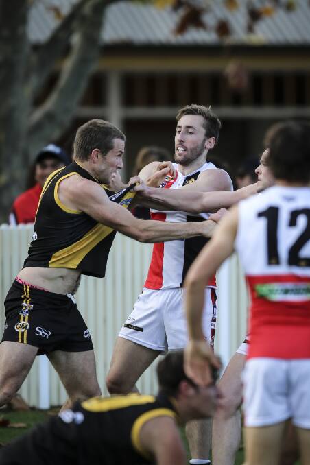 FIERY GAME: Albury's Chris Hyde comes to grips with his Myrtleford opponents in Saturday's feisty match. Picture: JAMES WILTSHIRE