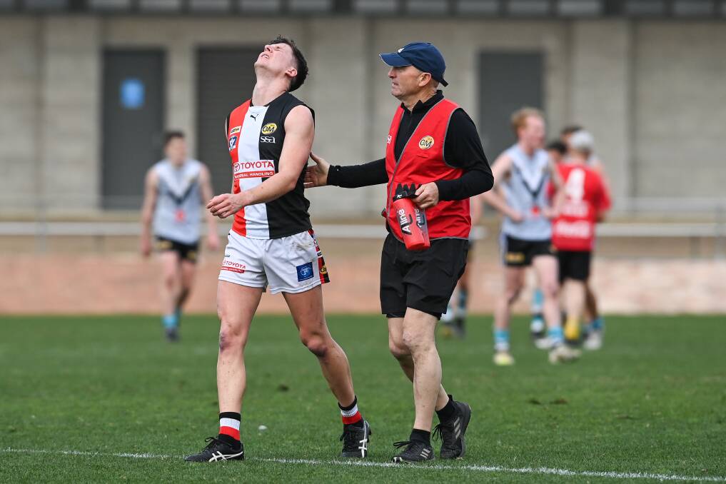 CRYING GAME: Myrtleford's Kurt Aylett leaves Lavington Sportsground in tears after he re-injured his left hamstring on Saturday. Aylett has been cruelled by injuries in his long career, which includes the AFL. Picture: MARK JESSER