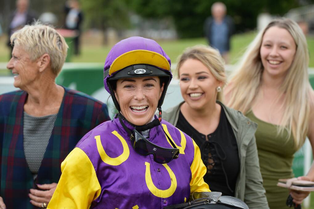 Jockey Amanda Masters shows her delight after winning the third race at Albury's Melbourne Cup meet.