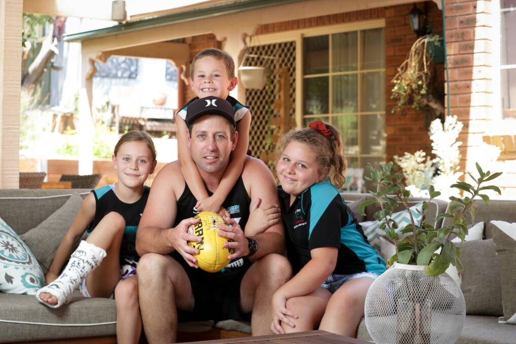 HERE'S HOPING: Lavington's Matt Pendergast had some quiet time with Pippa, 9, (left), Jagger, 6, and Leni, 11, and he's hoping he can return from injury to play his 300th game in front of family this year. Picture: JAMES WILTSHIRE