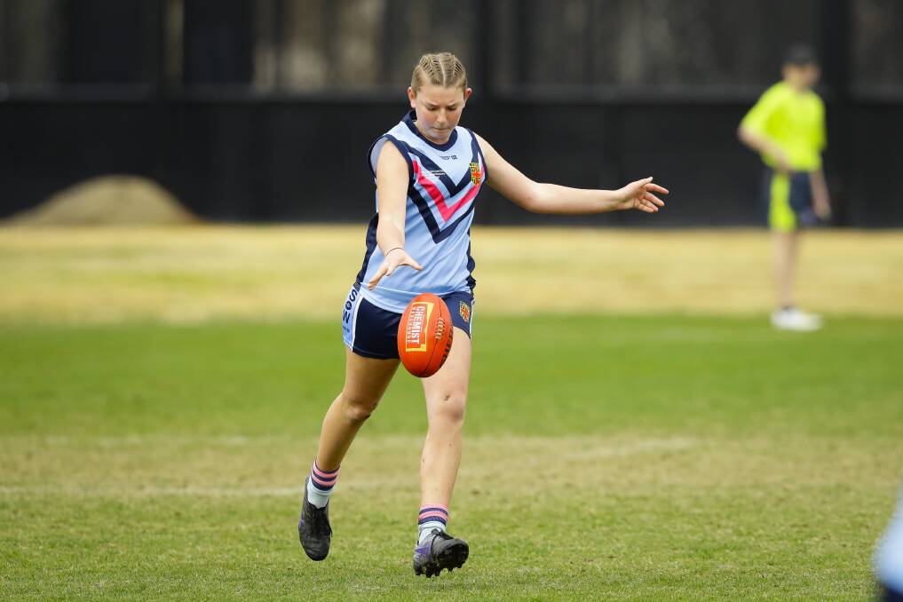 North Albury Xavier High School's Rose Bell looks to send NSW on the attack against Queensland in the national under 15 titles at the Lavington Sportsground complex.