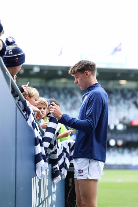 Connor O'Sullivan signs autographs on his debut day. Picture by Brad McGee Geelong Cats