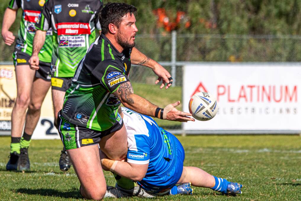 POWER FORWARD: Albury Thunder's back-rower Jon Huggett off-loads against Tumut on Saturday. The Blues had a superb second half in winning. Picture: KATHRYN MITSCH