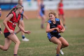 Xavier High School's Clare Hyland (right) plans her next move for NSW Combined Catholic Colleges against NSW Combined Independent Schools at Lavington Sportsground on Monday. Picture by James Wiltshire