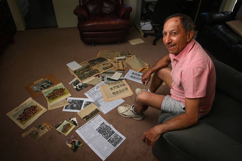 MEMORY LANE: Wangaratta-based John Bianco looks over some newspaper cuttings from Myrtleford's only premiership win. Picture: MARK JESSER 