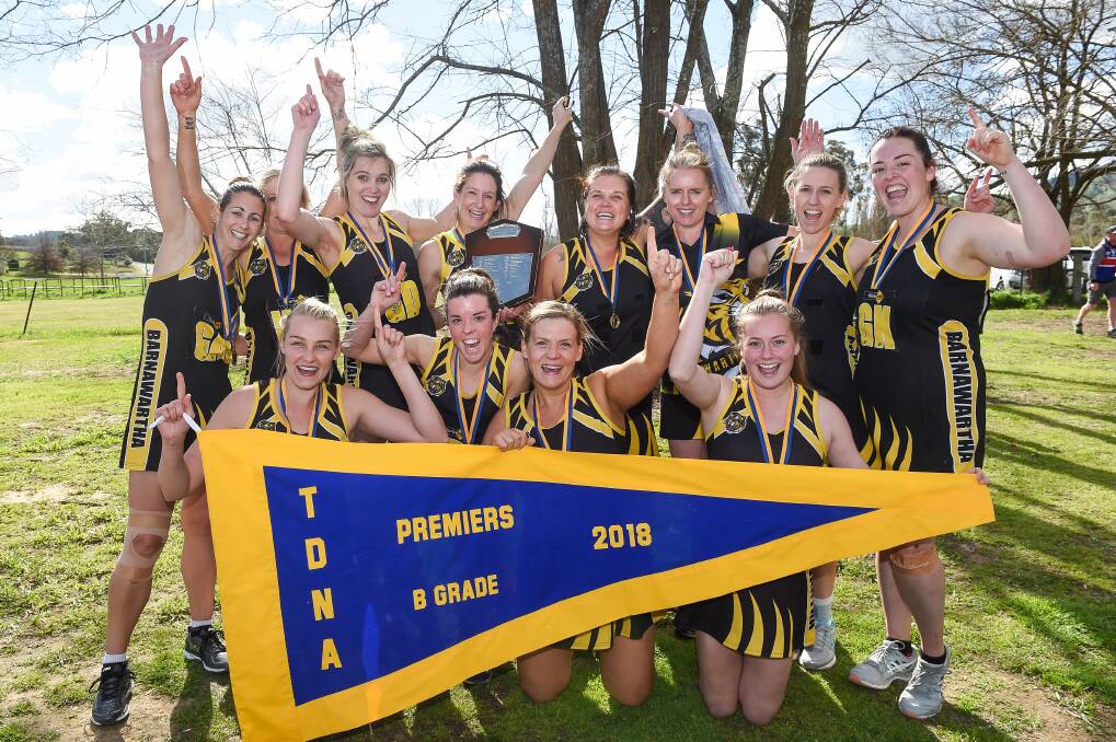 TIGER TOWN: Barnawartha players celebrate the B grade title. The Tigers toppled Thurgoona by three goals.