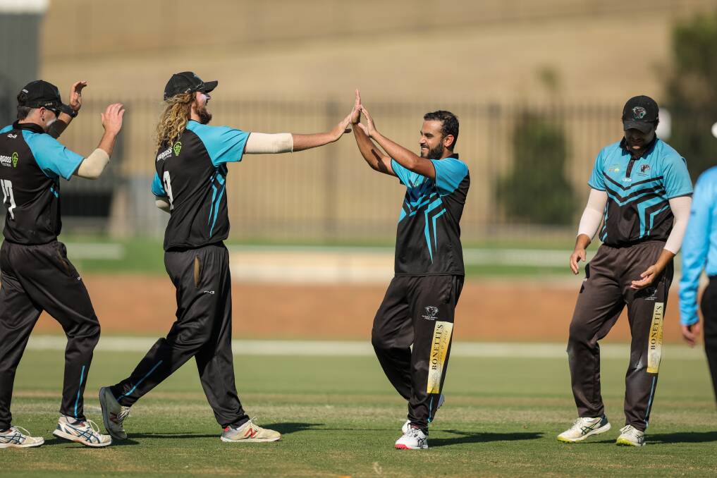 Shayan Shayan (centre) claims a wicket.