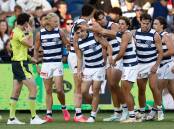Geelong's Shaun Mannagh (centre) is congratulated after kicking a goal against North Melbourne on March 1. He will now make his AFL debut. Picture by Getty Images