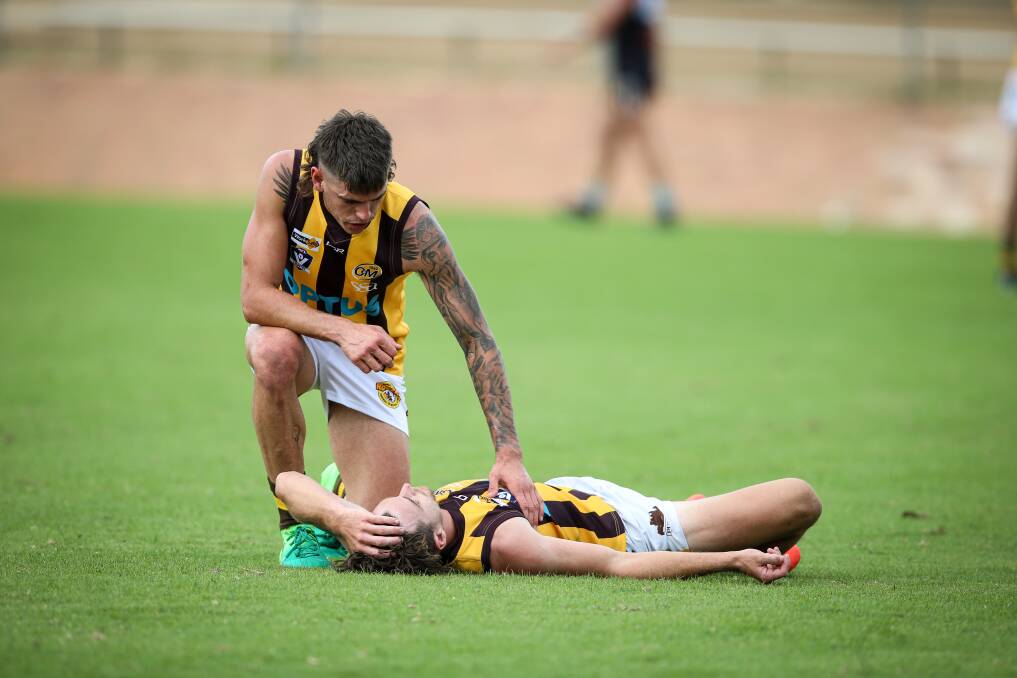 CONCUSSED: Wangaratta Rovers' Stuart Booth took a heavy knock against Lavington, as concerned team-mate Alex Marklew looks on. Pictures: JAMES WILTSHIRE