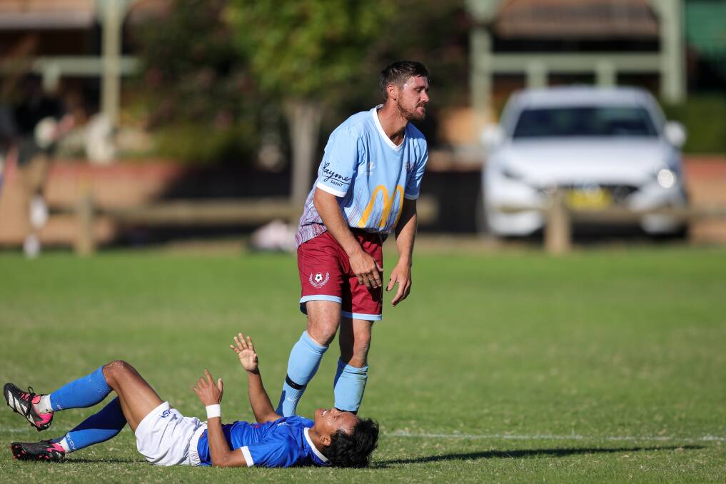 Twin City Wanderers' Josh Zito appears resigned to receiving a yellow card after his tackle against Myrtleford Savoy on Sunday. Picture by James Wiltshire