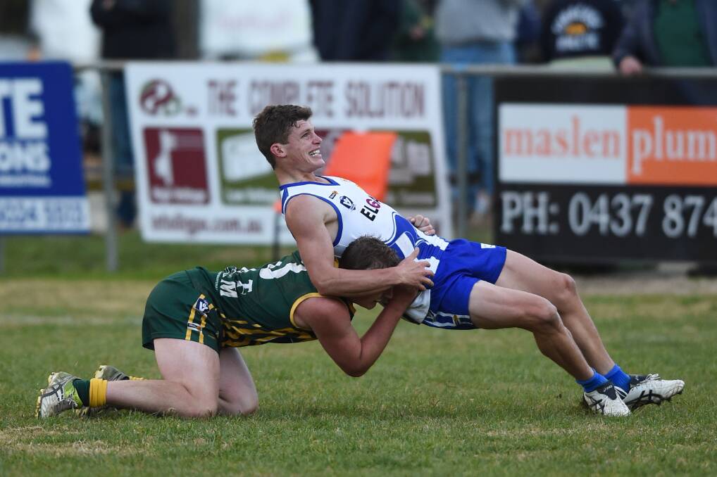 FUN TIMES: Yackandandah's Nathan Ford seems to be enjoying this clash against Tallangatta's Thomas Russell. Ford was smiling even more when the Roos won.