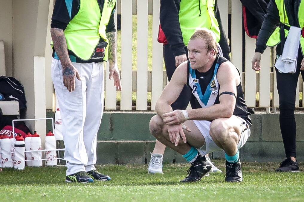 OUCH: Lavington's Marty Brennan popped his dislocated finger back
in during a war of attrition against Albury. Picture: JAMES WILTSHIRE