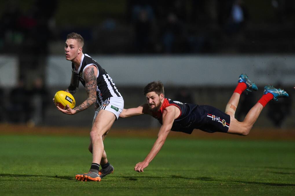 Ethan Boxall shows his desperation against Wangaratta's Mitch Jensen in the 2018 qualifying final under lights at Lavington Sportsground.