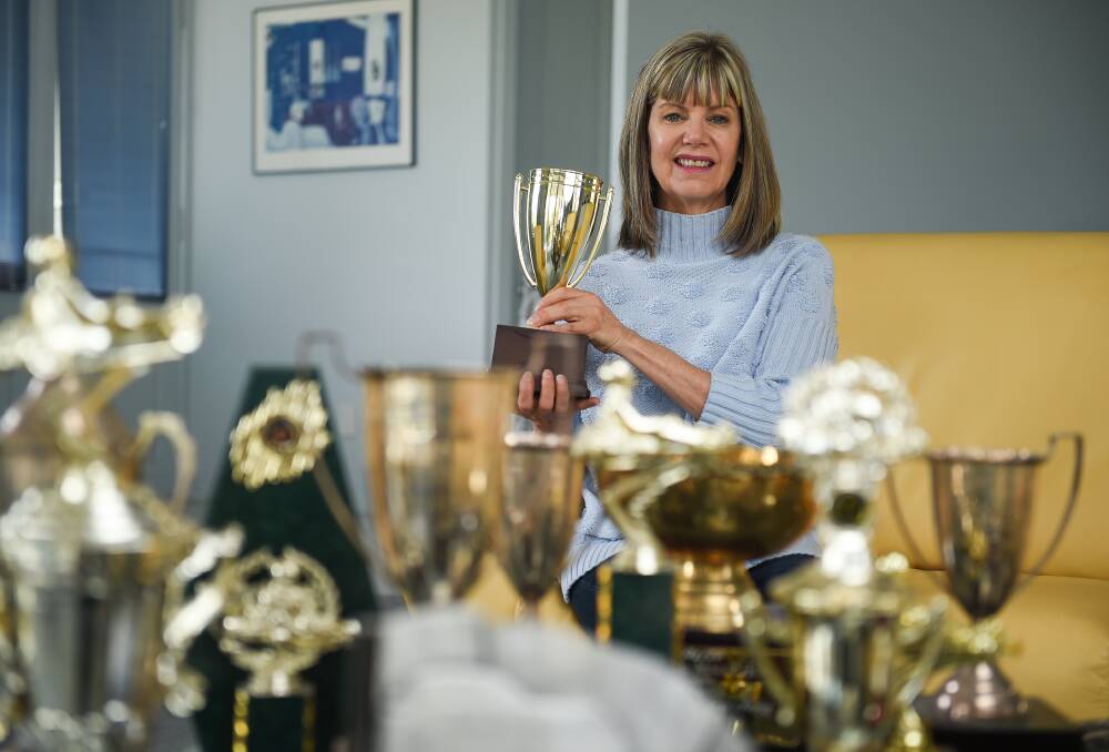 TROPHY ROOM: Albury's Sue Reynolds with some of the trophies
her son David has won during his 25 years in motor sport.
Picture: MARK JESSER