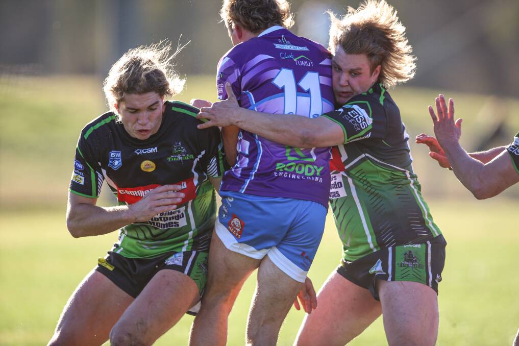 HAIR-RAISING: Albury Thunder's Mason Fuller (left) and Darcy Wilson combine for a heavy tackle on Tumut second-rower Tom Jeffery on Saturday.