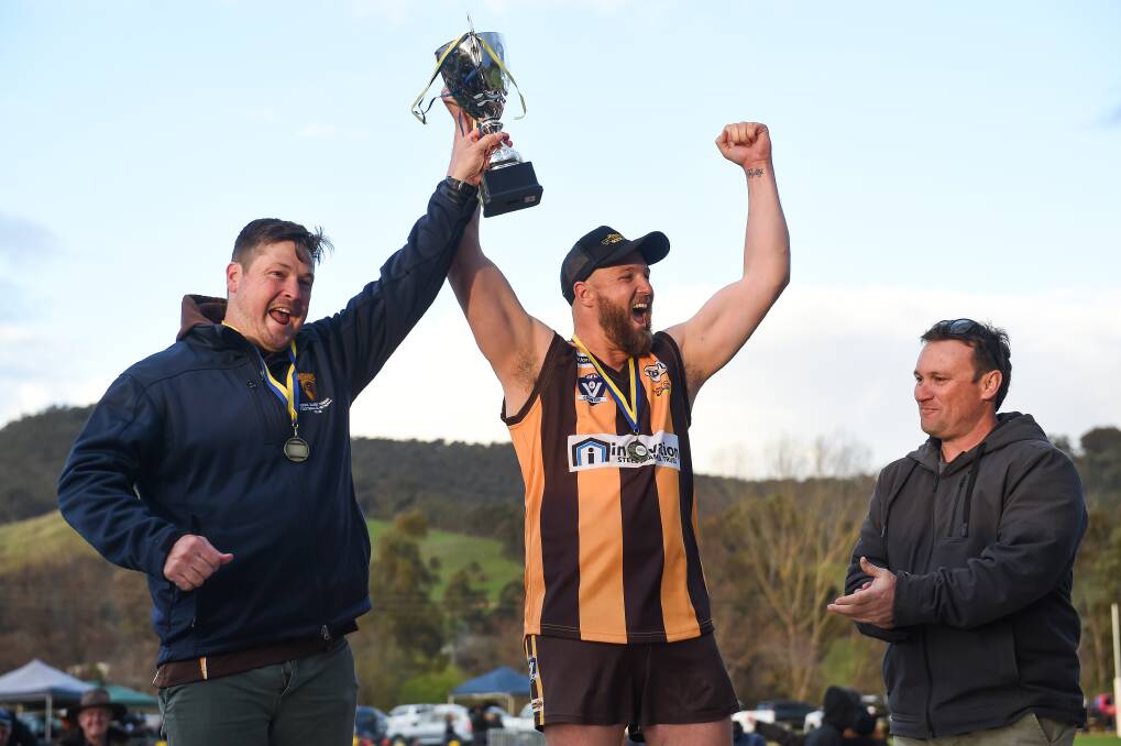 JUBILANT: Hawks' coach Adam Mudra (left) and Guy Telford share that special feeling of lifting the premiership cup after the Hawks claimed their first title since 2014.