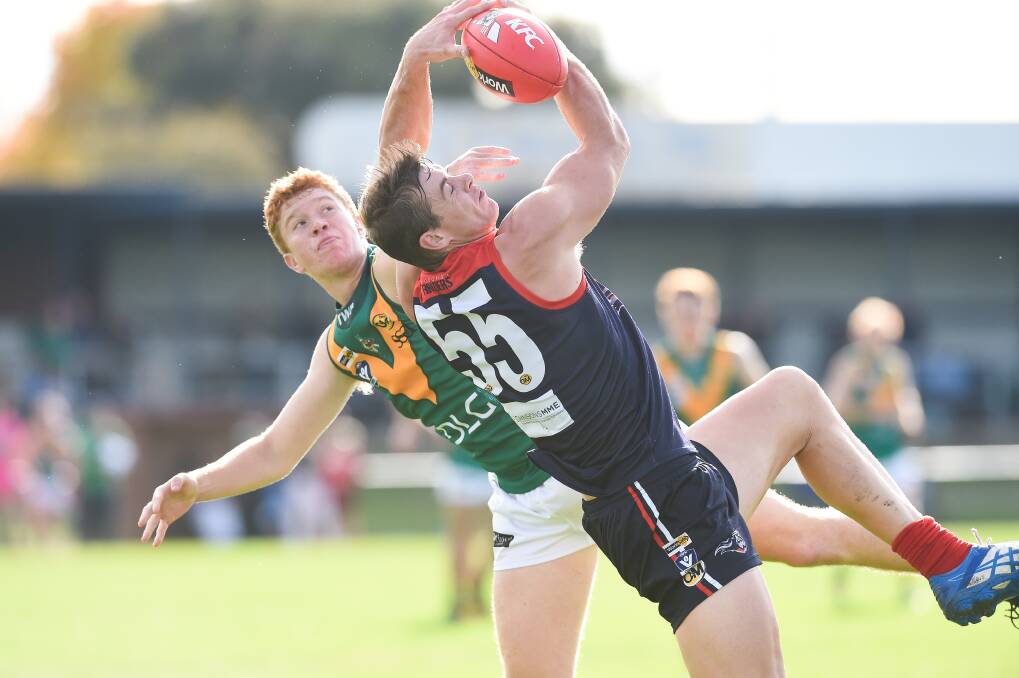 STRONG MARK: Raiders' Brodie A'Vard battles North Albury's Jackson Weidemann. A'Vard took a series of strong grabs and booted three goals in the thumping win.