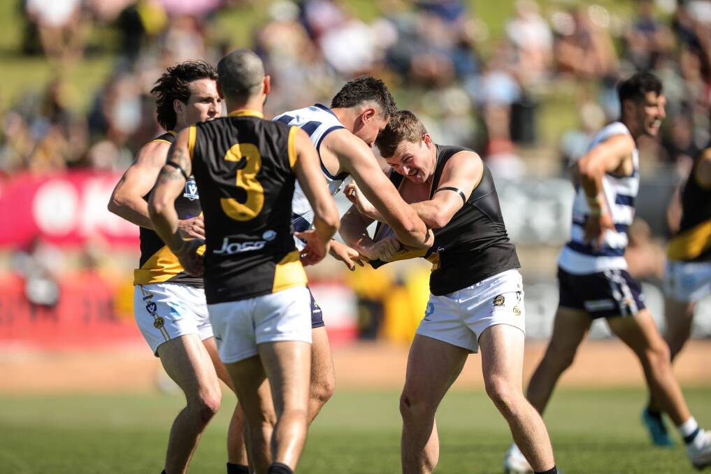 Kyal Tyson (centre) tangles with Albury's Elliott Powell in the grand final.