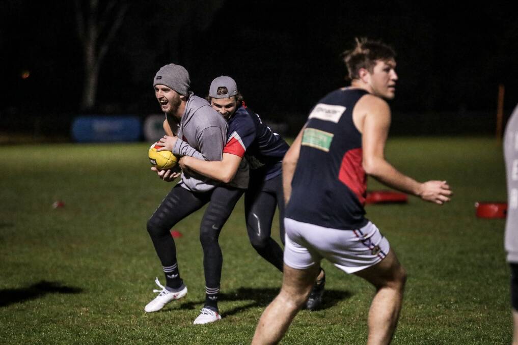 LOL: Sam Murray (left) can see the funny side of Jaxon Neagle's tackle
at Wodonga Raiders' training on Thursday night. Picture: JAMES WILTSHIRE