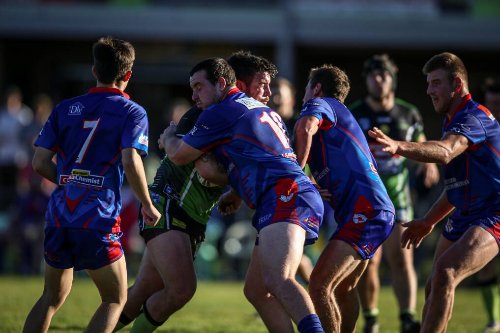 Albury Thunder's Jon Huggett charges into Wagga Kangaroos' defence on June 20, but he won't be able to tackle them in the return clash as COVD protocols have ruled out too many players to proceed.