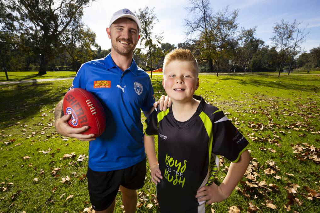 HAPPY DAYS: Corowa-Rutherglen's Jarryd Hatton works with Tom Davies 10, at Boys To The Bush and the youngster was only to happy to join in the fun. Picture: ASH SMITH