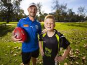 HAPPY DAYS: Corowa-Rutherglen's Jarryd Hatton works with Tom Davies 10, at Boys To The Bush and the youngster was only to happy to join in the fun. Picture: ASH SMITH