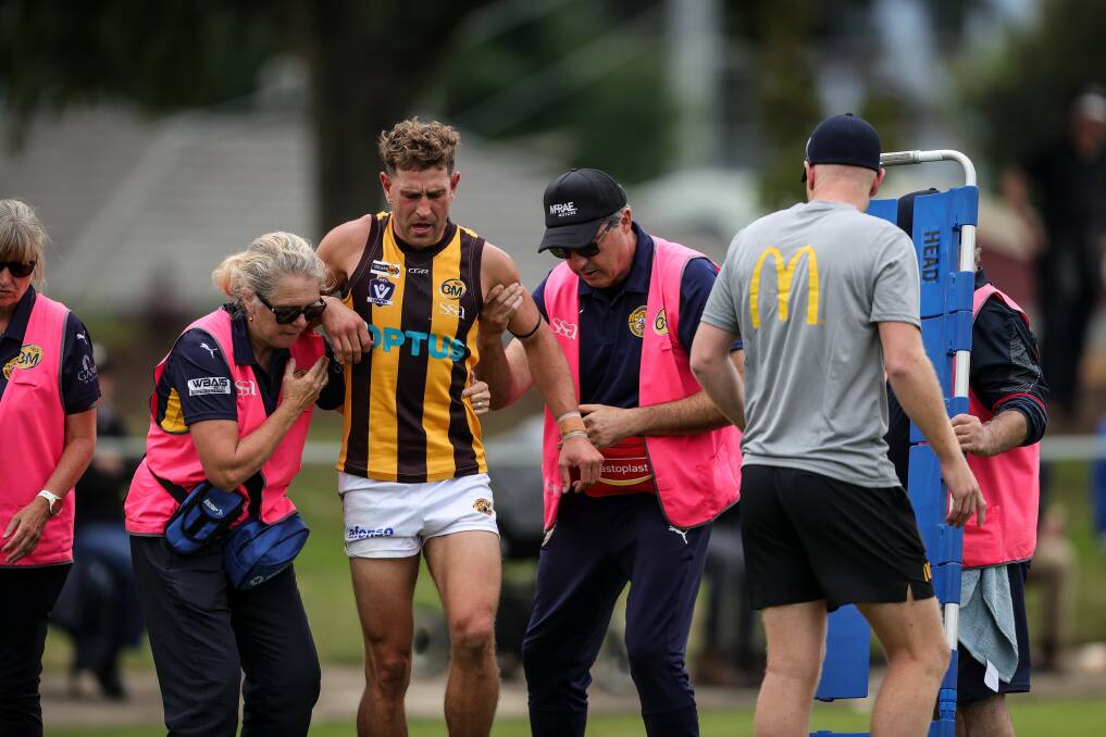 Wangaratta Rovers' Ryan Stone is helped off after injuring his left knee in the team's hard-fought seven-point win over Wodonga Raiders. Picture by James Wiltshire