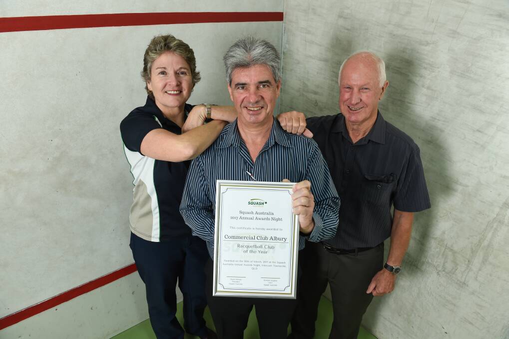 Squash and Racquetball Victoria's Fiona Young presents Australia's top gong to Commercial Club members Mark Treloar and Ross Falconer. Picture: MARK JESSER
