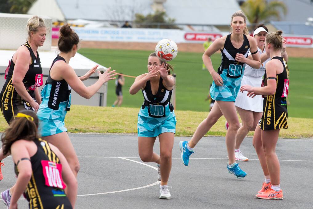 ON THE RUN: The Panthers' Caitlyn Gerecke fires out a pass to team-mate Kate Yensch in the Panthers' win over Albury. The win has virtually sealed top spot.