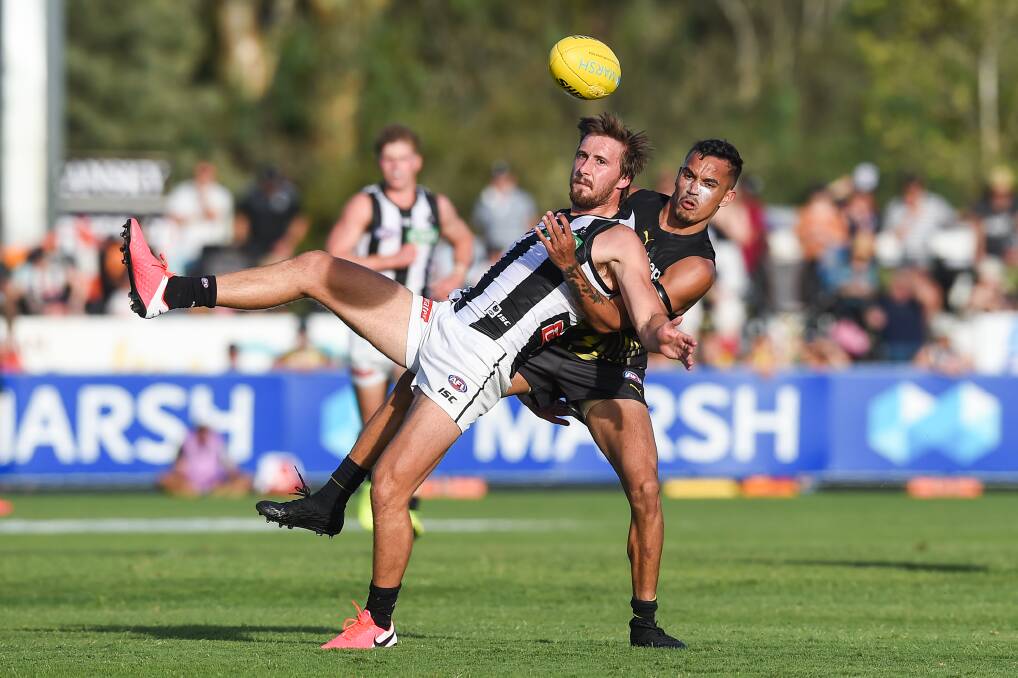 TIGHT MARKING: Tom Phillips is well held by Sydney Stack, but the Pie was able to kick a goal and impress coach Nathan Buckley.