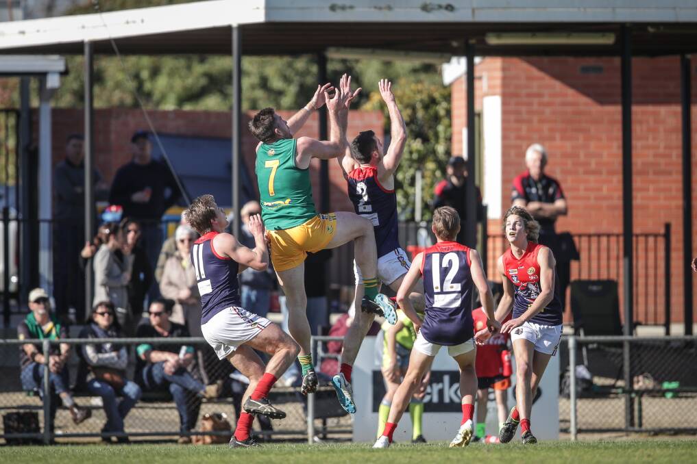 HANG TIME: North Albury coach Isaac Muller (7) flies into the back of Raiders' Lachie Flagg during the final round game. Picture: JAMES WILTSHIRE