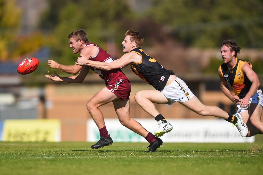 Wodonga's Reed Jackson is tackled by Albury's Fraser Duryea in his last season of football in 2019. He's since built a house and travelled.