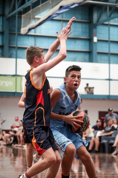 EFFORT: Kookaburras' Dylan Jett Tea is blocked by the Wombats' Jackson Bowden in their opening game in the Australian Country Junior Basketball Cup.