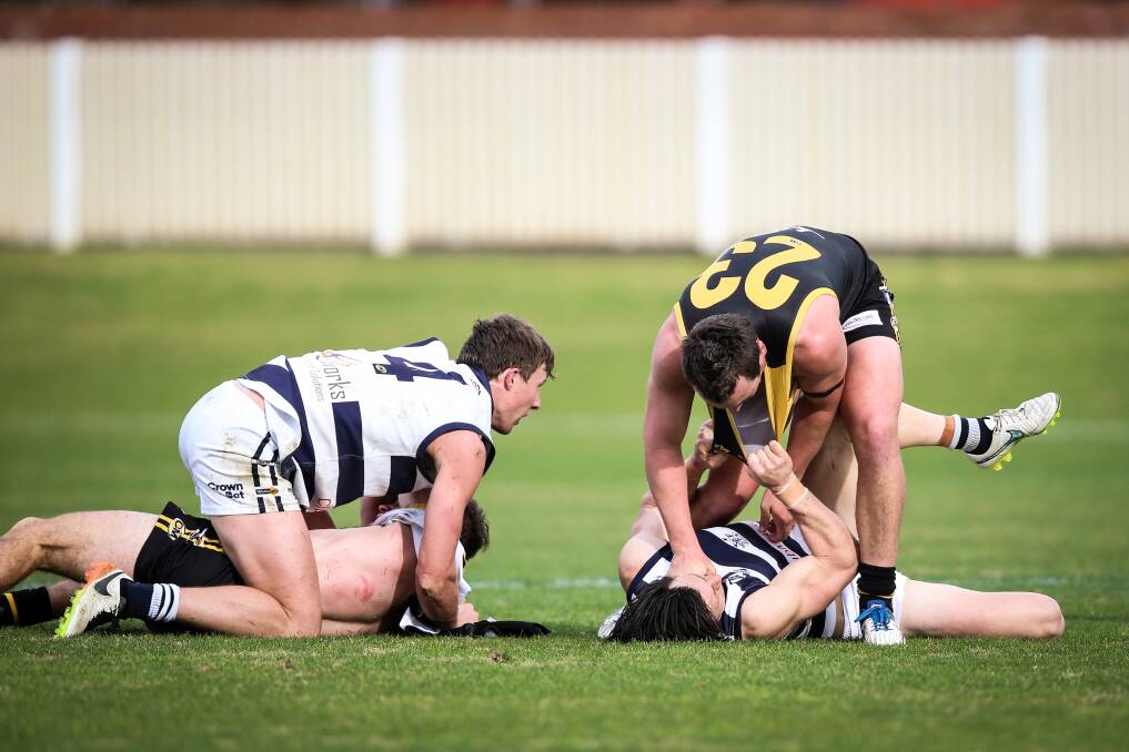 LET'S GET PHYSICAL: Albury and Yarrawonga did that with Mark Whiley on top of Will Blomeley (left), while Alex Jones has Tyler Bonat pinned. Picture: JAMES WILTSHIRE