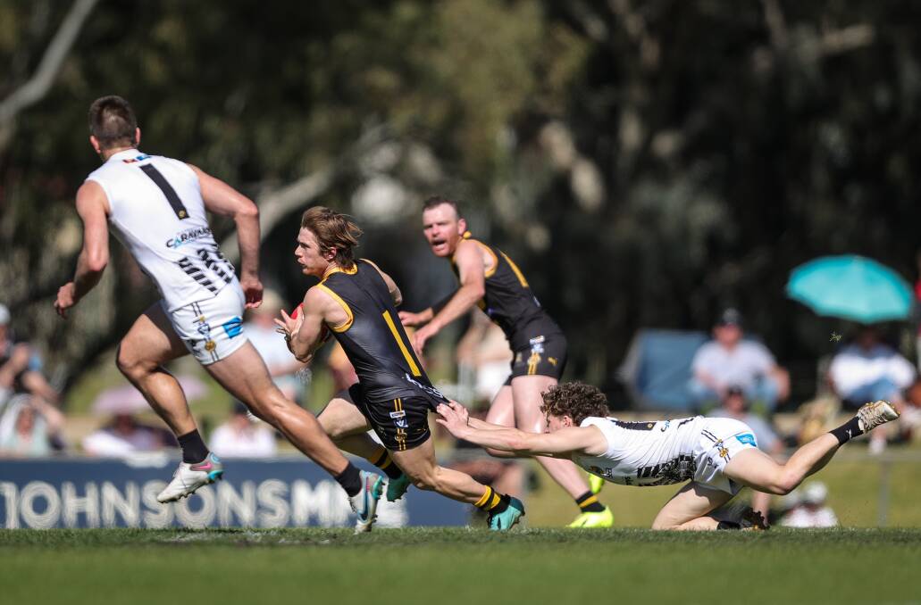 Albury's Jake Gaynor is caught by Wangaratta's Braeden Marjanovic during yesterday's preliminary final. Gaynor was outstanding in the 41-point win. Picture by James Wiltshire