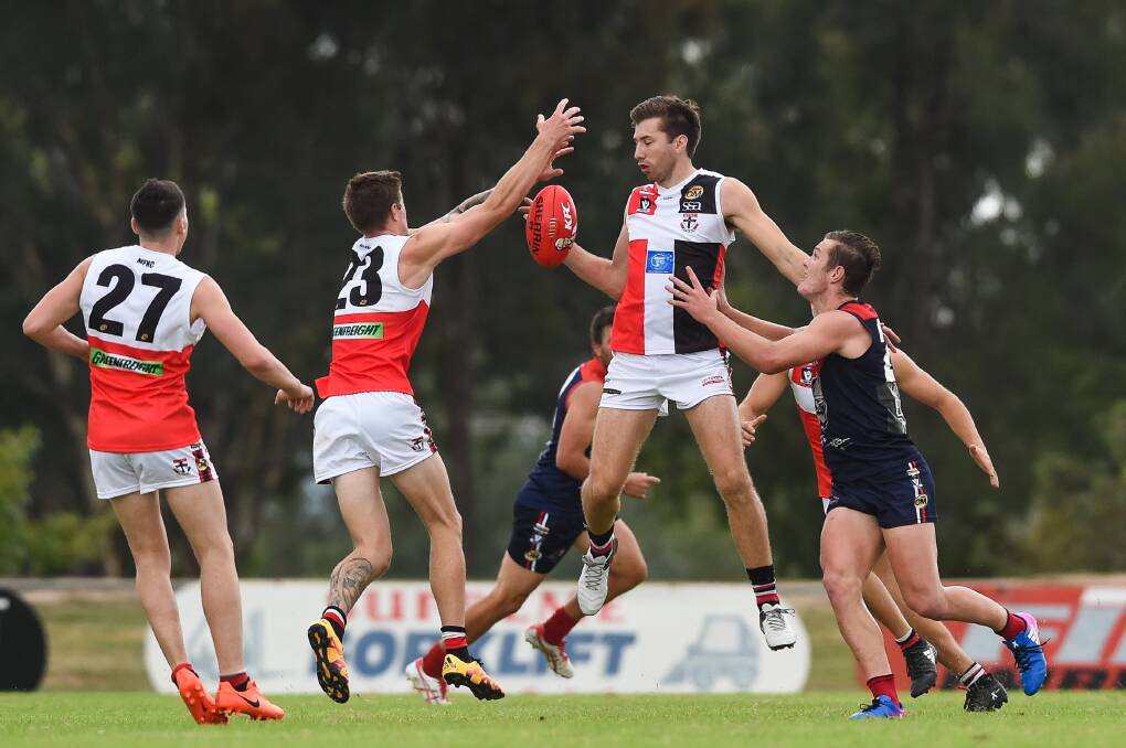 TALL TIMBER: Riley O'Shea (with ball) and Tom McDonagh (23) are just two of the Saints' players more than 183 centimetres.