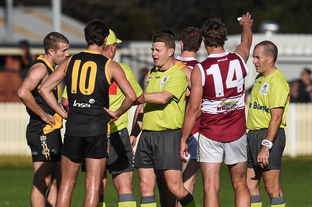 BUSY BOYS: The umpires were kept extremely busy as Albury and Wodonga produced a fiery and physical clash.