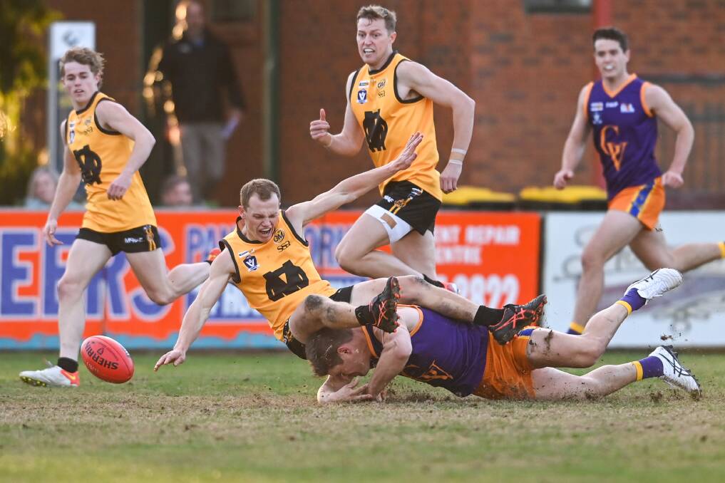 CRASH LANDING: O and M's Cam Wilson lands on his Goulburn Valley opponent in Saturday's interleague match. Picture: MARK JESSER