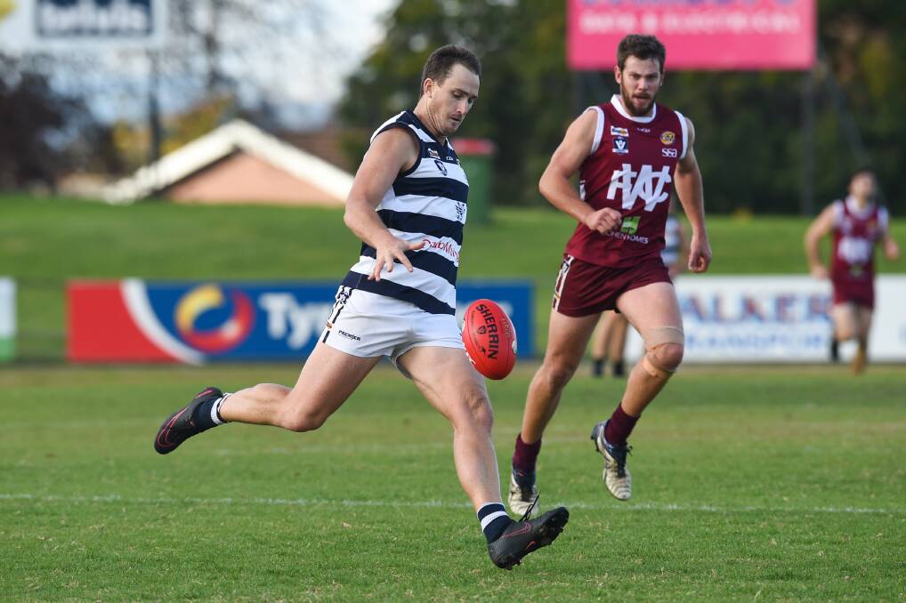 MOTOR RUNNING: Yarrawonga's Marcus McMillan, nicknamed Motor, sends the ball into attack against Wodonga. Picture: MARK JESSER