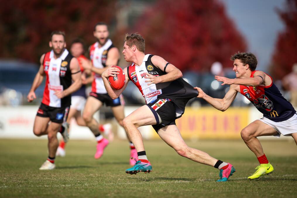 Myrtleford (with ball) is one of six Ovens and Murray clubs which asked AFL North East Border for extra player points in 2022.